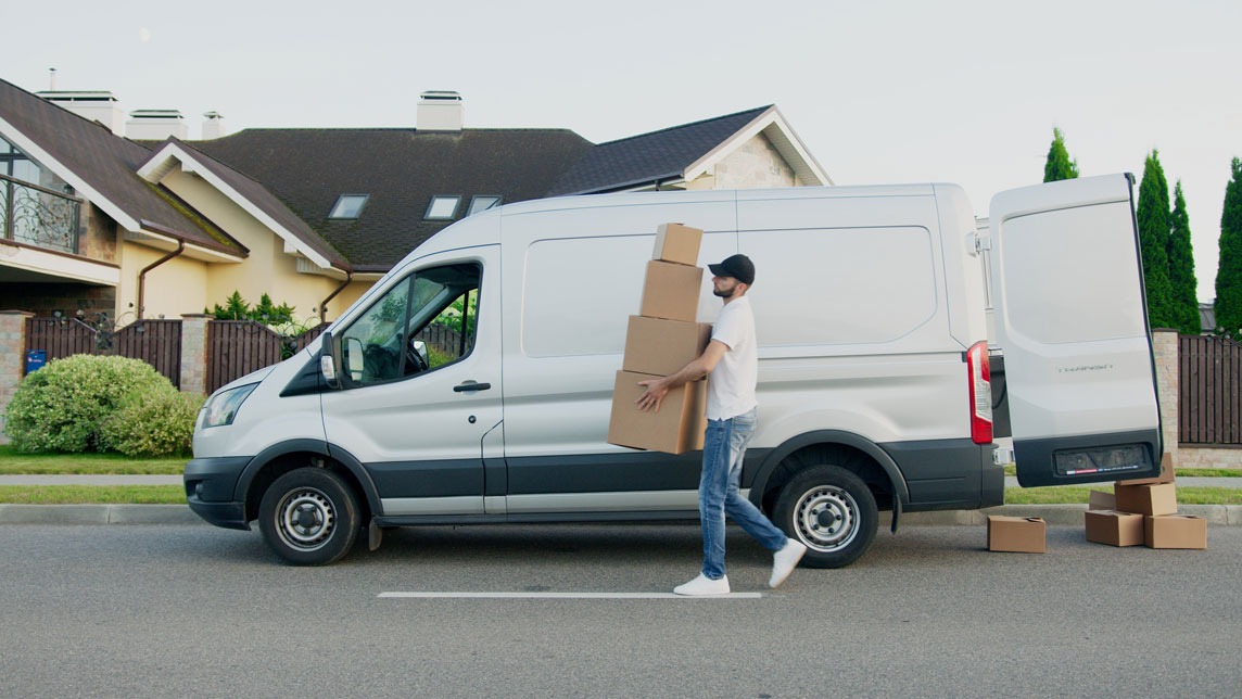 A man loading boxes to a van.